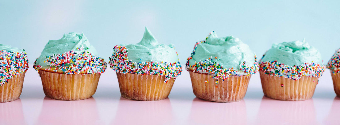 Several Cupcakes with blue frosting and Sprinkles in a row