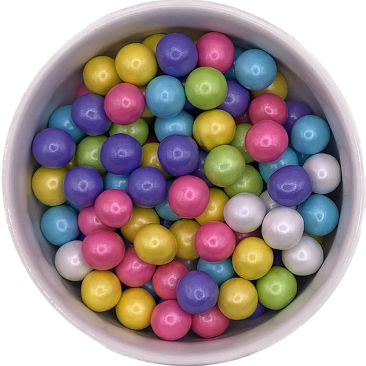 This image features a vibrant assortment of round, multicolored sugar pearls in a variety of colors including yellow, green, pink, purple, blue, and white. These decorative edible pearls are perfect for adding a pop of color and a touch of elegance to cakes, cupcakes, cookies, and other sweet treats.
