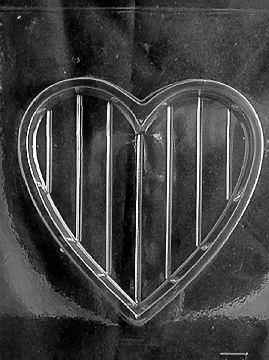 Clear plastic mold showing a 7-inch heart-shaped chocolate box base with vertical grooves, designed to pair with a plain top.