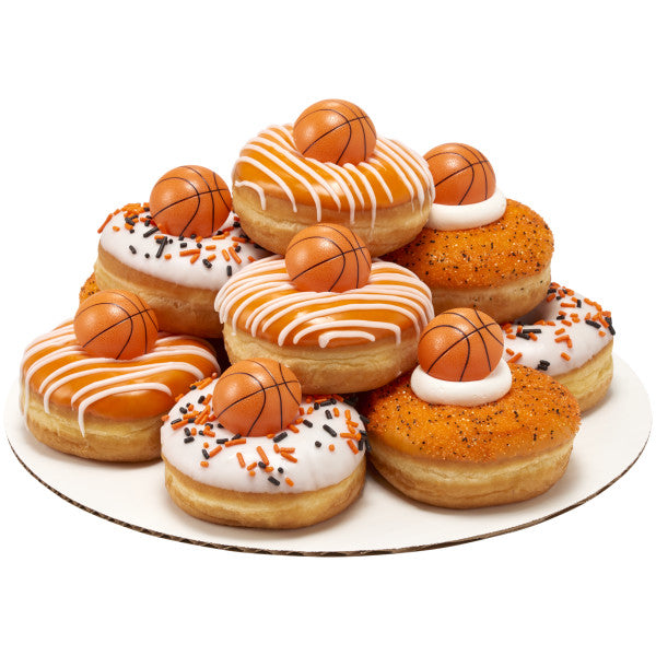 Stack of decorated donuts topped with 3D basketball rings, white and orange frosting, and themed sprinkles.