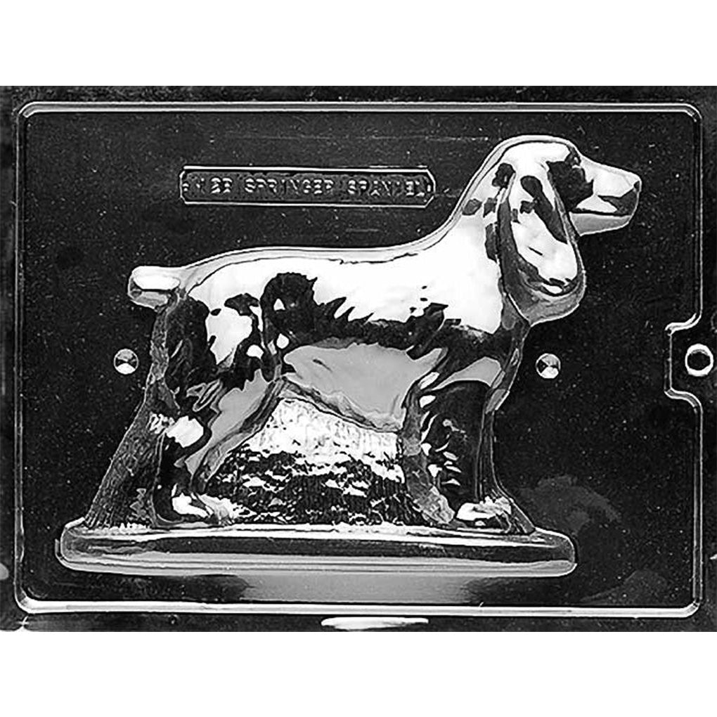 Two-piece clear plastic chocolate mold showing a standing Springer Spaniel shape with an engraved label area, photographed on a dark background.