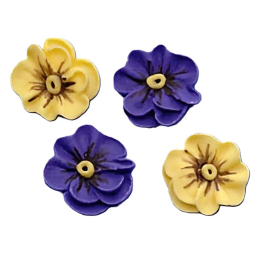 Four 3/4 inch pansy royal icing decorations with petals in shades of yellow and purple, each with detailed central markings. The lifelike appearance of these decorations makes them an excellent choice for adding a touch of floral elegance to cakes and cupcakes.