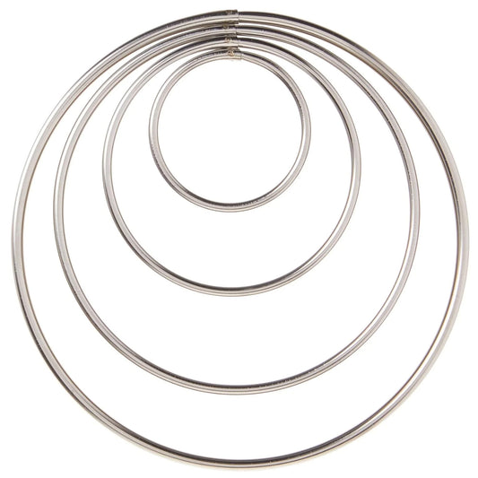 Top-down view of four round cutters nested concentrically, forming a target-like set of circles on a white background.