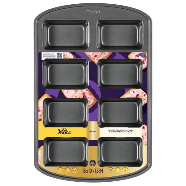 Wilton Gold non-stick 8-cavity mini loaf pan, dark gray with extended handles; eight rectangular wells for baking mini breads or cakes; packaging card visible on pan surface.
