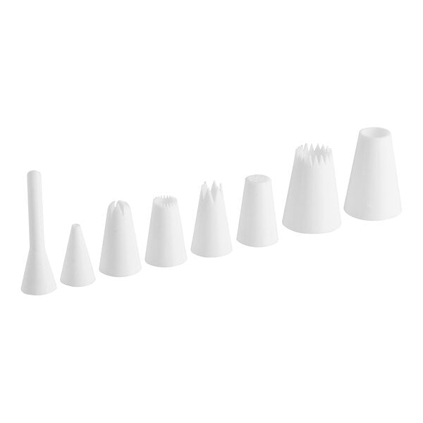 Set of 8 white plastic piping tips arranged in a row, showcasing different shapes and sizes for cake decorating.