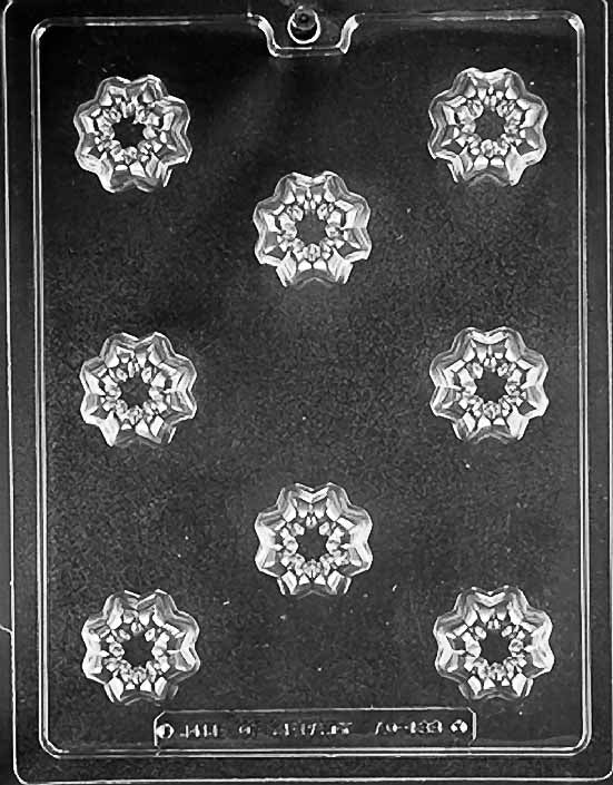 Clear plastic chocolate mold with nine cavities in a flower shape, used for making candy or chocolate.
