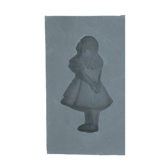 Close-up view of Alice in Wonderland rubber mint mold showing the detailed figure of Alice standing with hands behind her back. Ideal for themed candy making.