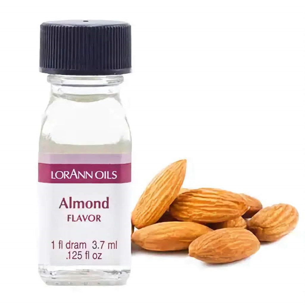 Small bottle of LorAnn Oils almond flavoring with almonds beside it.
