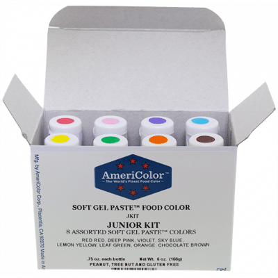 Open box of AmeriColor Soft Gel Paste Junior Kit showing eight color-coded bottles neatly arranged in a row for easy access and use.