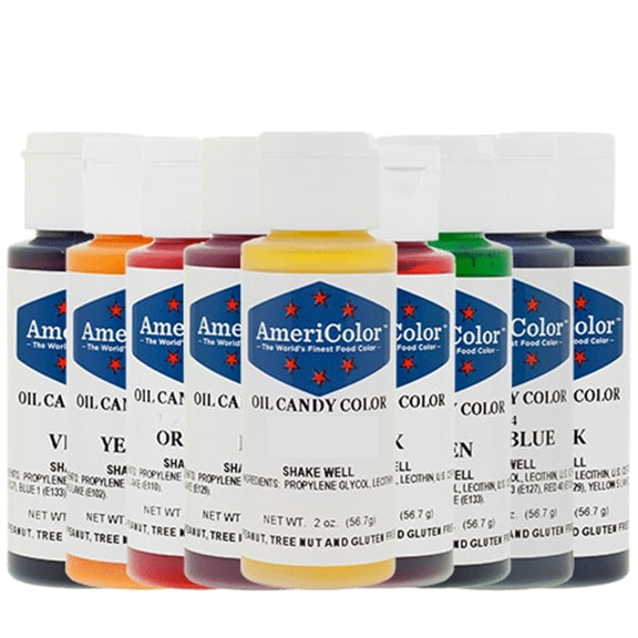 Row of AmeriColor Oil Candy Color 2 oz bottles in assorted colors, designed for chocolate and candy making with an oil-based formula for smooth blending.
