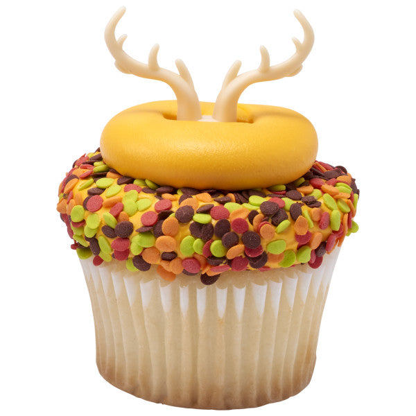 Fall-themed cupcake with yellow fondant and colorful confetti sprinkles, topped with antler ring