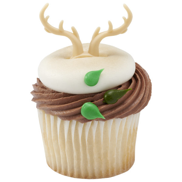 White and chocolate frosted cupcake with green leaf accents and antler topper