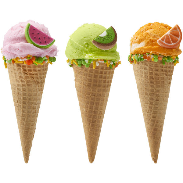 Trio of ice cream cones each topped with a different fruit slice sugar decoration—watermelon, kiwi, and orange.