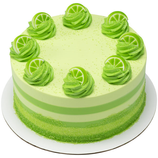 Lime-themed cake decorated with green frosting swirls topped with lime slice sugar decorations.