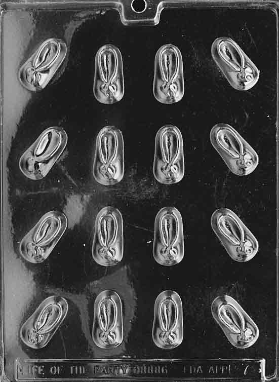 Clear mold with tiny baby bootie cavities showing strap and sole lines; shallow depth.