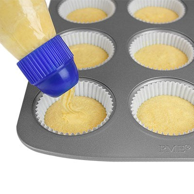 PME batter dispenser in use, filling cupcake liners evenly in a muffin tin.
