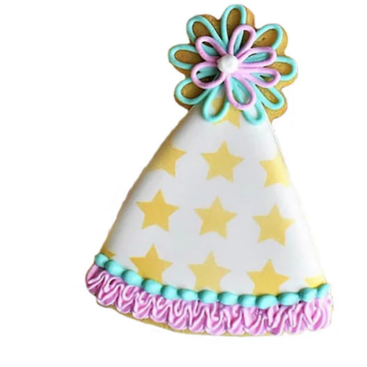Birthday Hat cookie cutter next to a decorated birthday hat cookie with star pattern and piped frosting details.