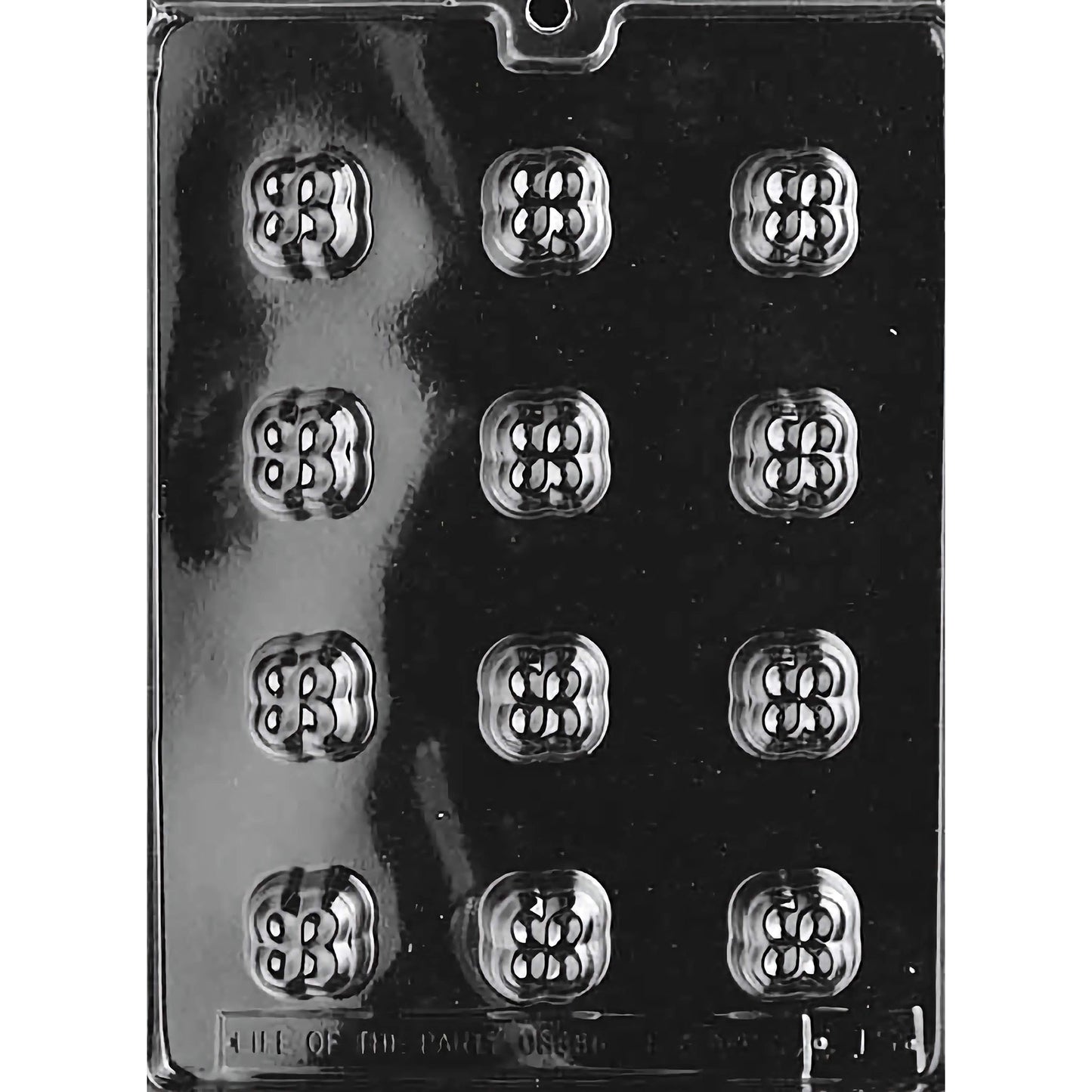 Clear plastic chocolate mold designed for making bite-sized clover-shaped chocolates, featuring twelve compartments arranged in three rows of four. Each compartment is intricately designed to resemble a four-leaf clover with detailed patterns.