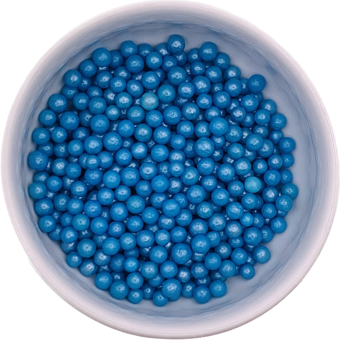 Overhead view of a white bowl filled with glossy blue 4mm sugar pearls, edible decorations for cakes, cupcakes, and cookies