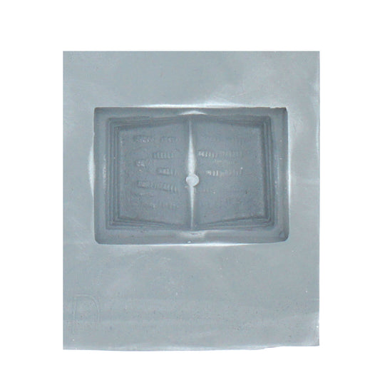 Close-up of a book-shaped cavity in a lead-free rubber mint mold, perfect for cream cheese mints, chocolates, or fondant decorations.