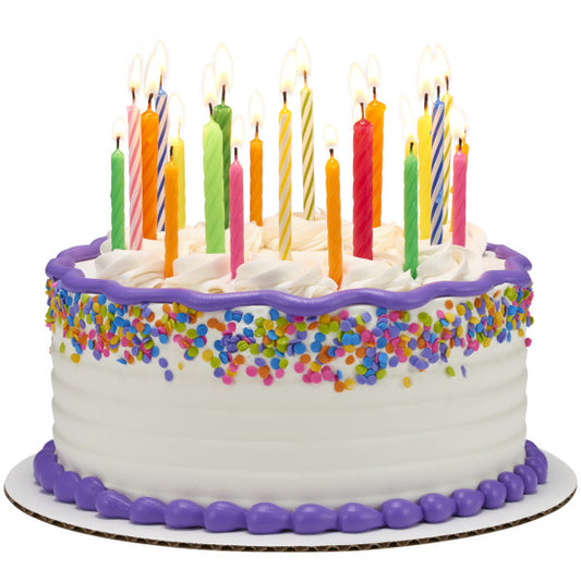 White frosted cake decorated with rainbow sprinkles and topped with tall spiral candles in assorted bright colors.