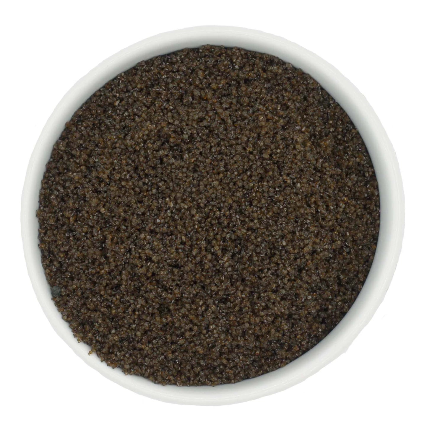 Top-down view of a white bowl filled with brown coarse sanding sugar crystals, showing chunky dark amber-brown granules with a subtle sparkling finish.
