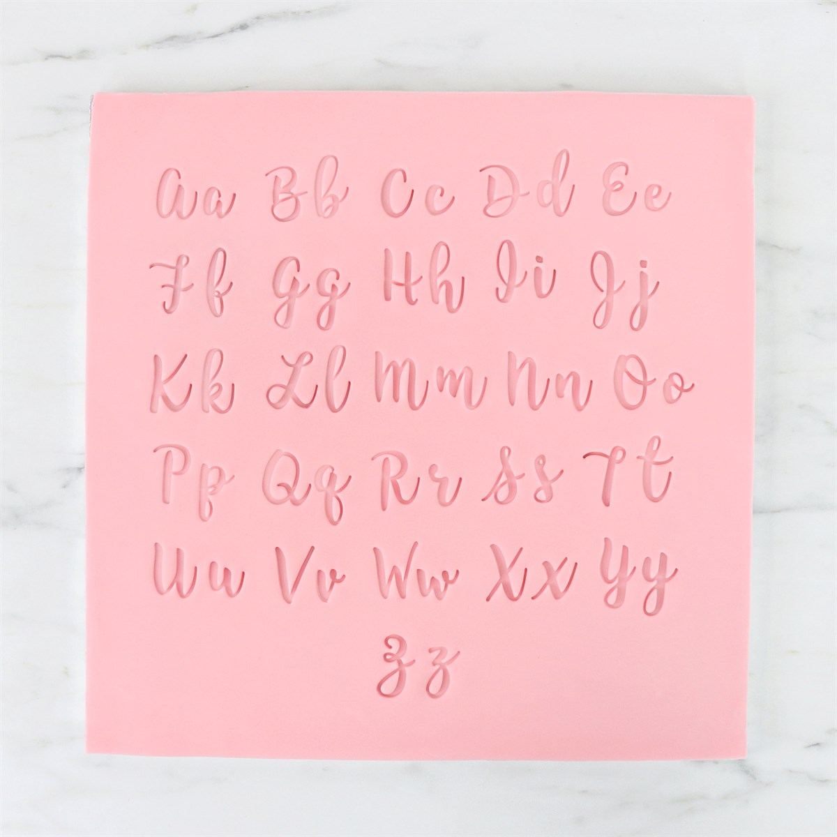 Alphabet impressions made with PME Fun Fonts stamps from Collection 1 in flowing script style.