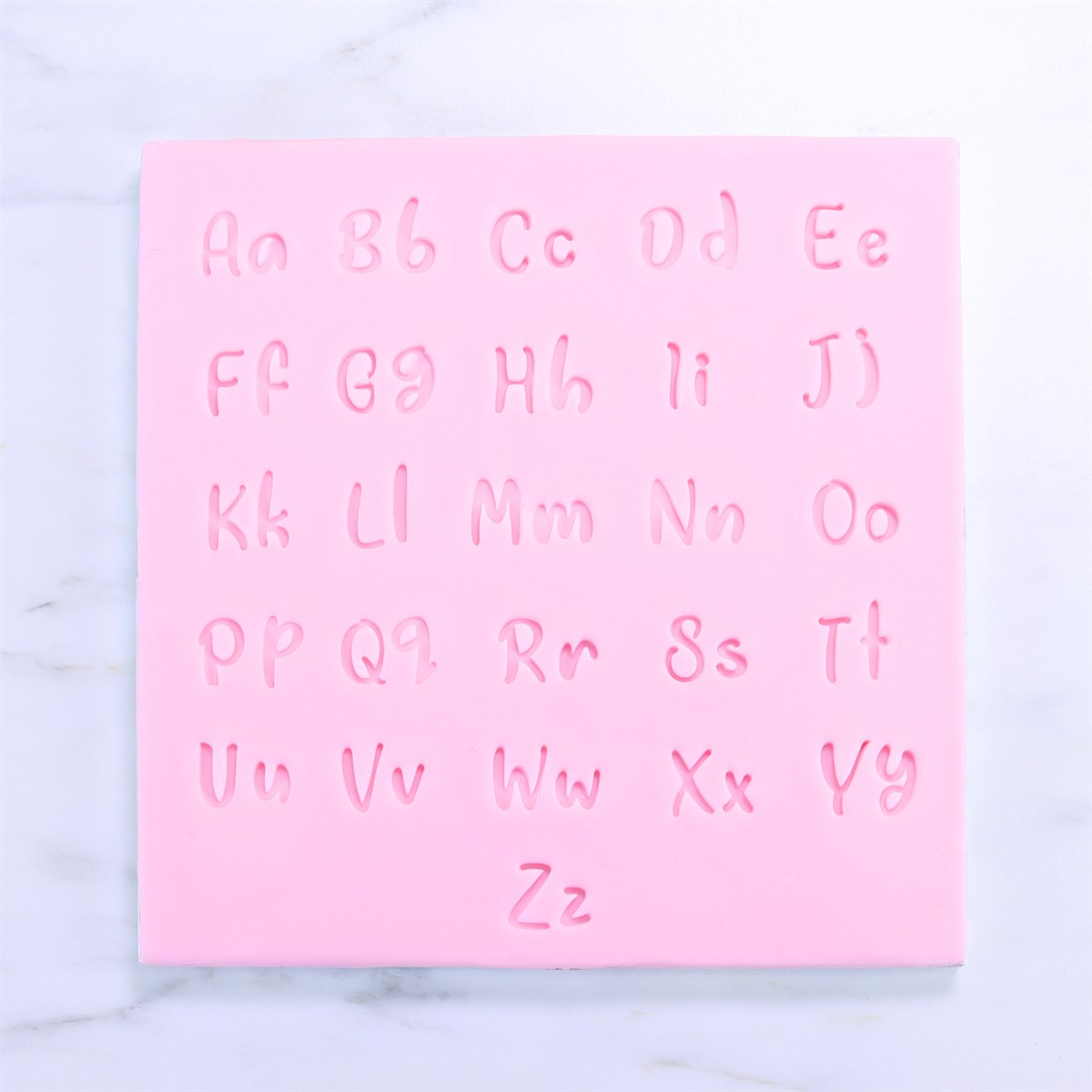 Close-up of pink silicone mat showing all uppercase and lowercase letters from the Fun Fonts stamp collection.