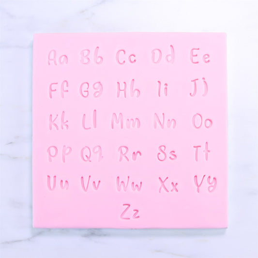 Close-up of pink silicone mat showing all uppercase and lowercase letters from the Fun Fonts stamp collection.