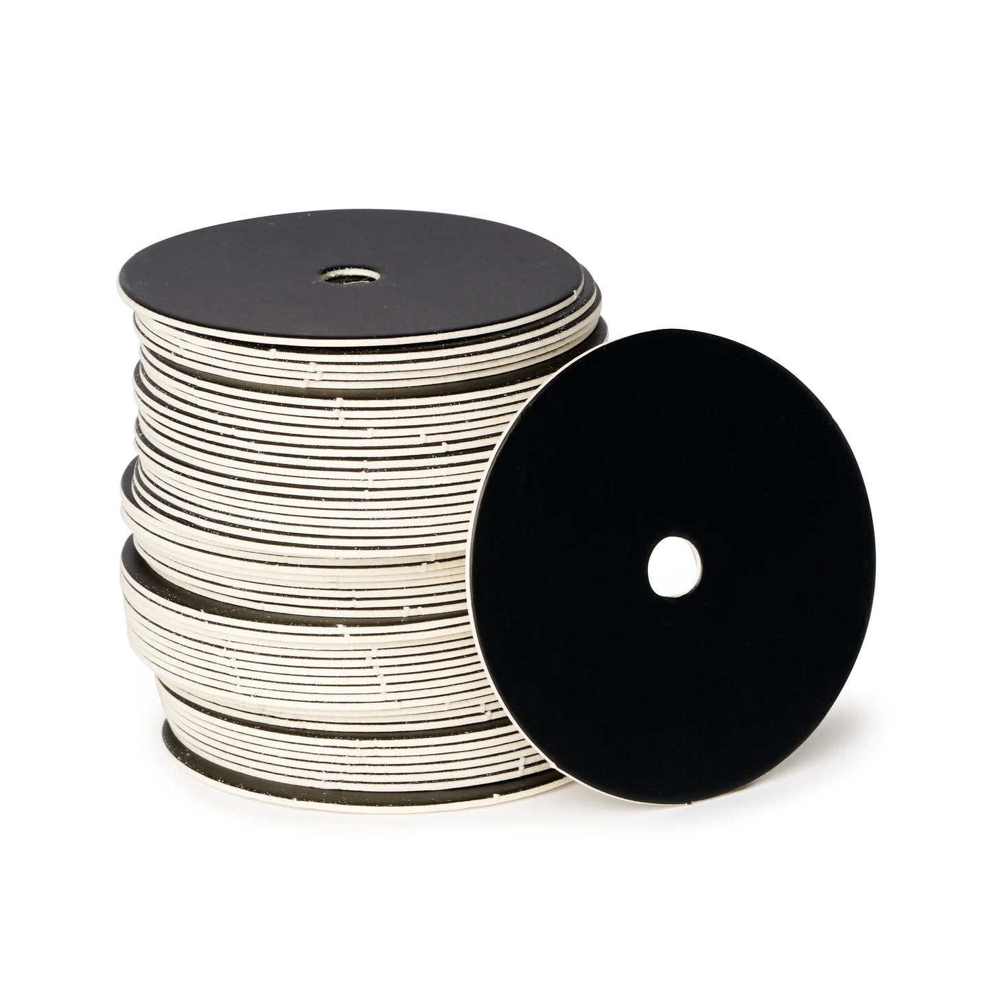 Stack of 2-inch round black matte cake pop boards with straight edges and center holes, shown in a vertical stack with one board facing forward.