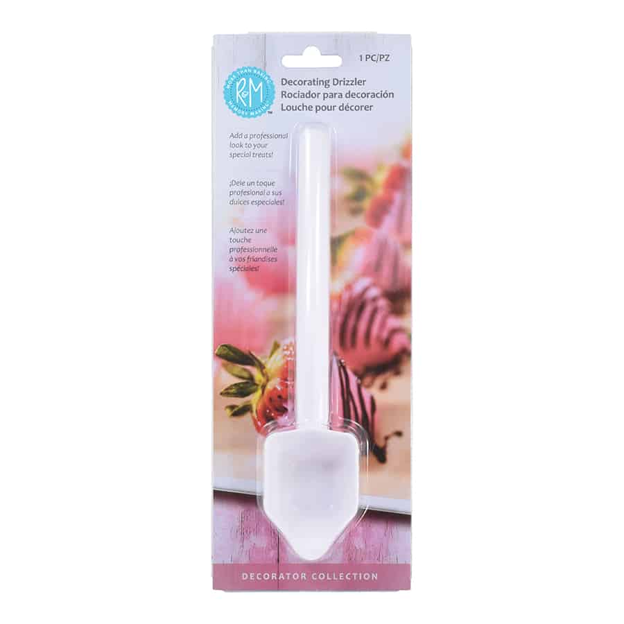 Front view of Chocolate Drizzler Decorating Tool in retail packaging, showing the tool and strawberries decorated with chocolate drizzle in the background.