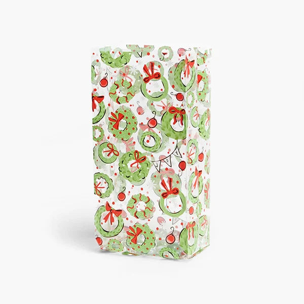 Clear Christmas Wreaths Cello Treat Bag featuring watercolor-style green Christmas wreaths with red bows, colorful ornaments, pink accents, and festive greenery.