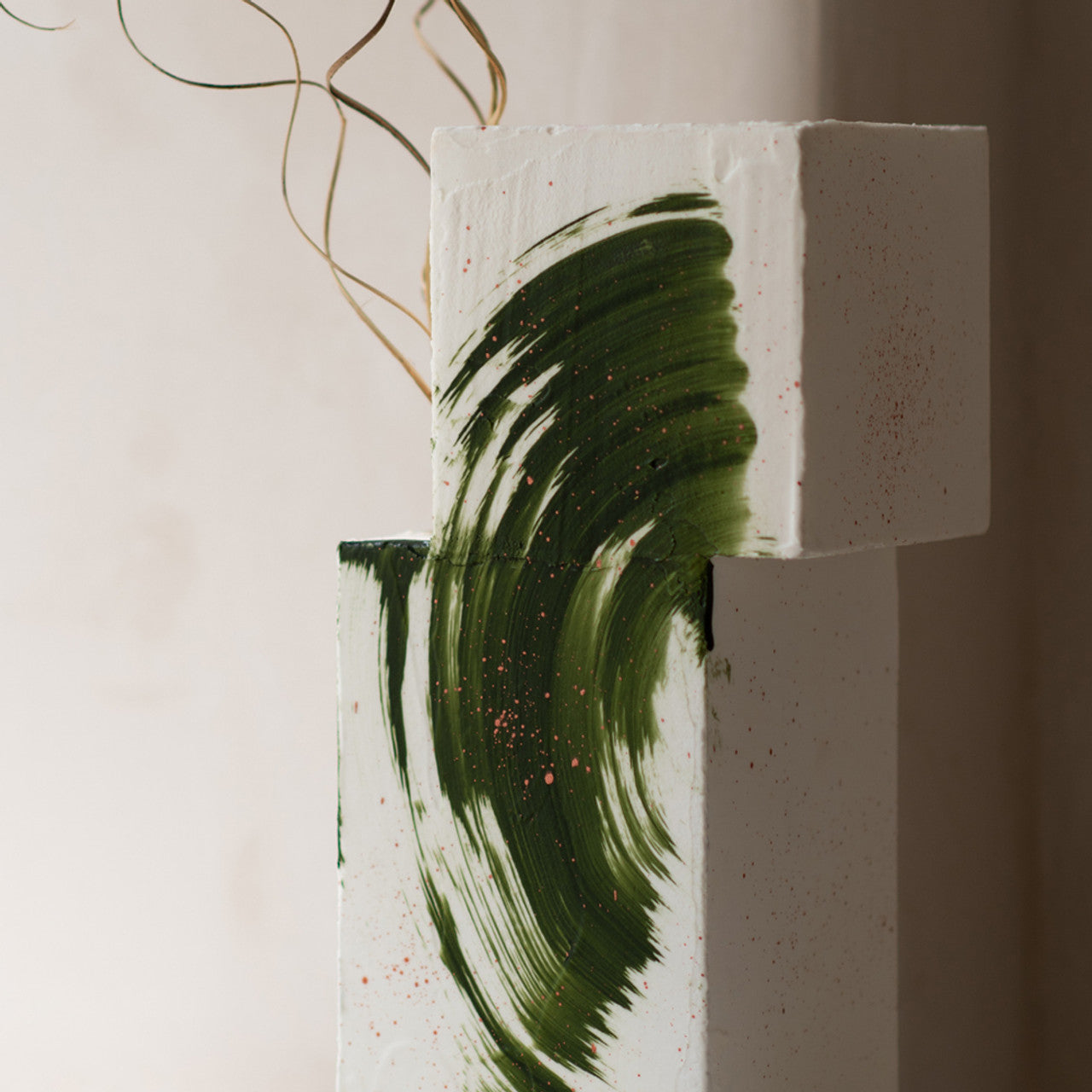 Modern white cake with bold olive green brushstroke created using Colour Mill Olive Oil Blend for an artistic finish