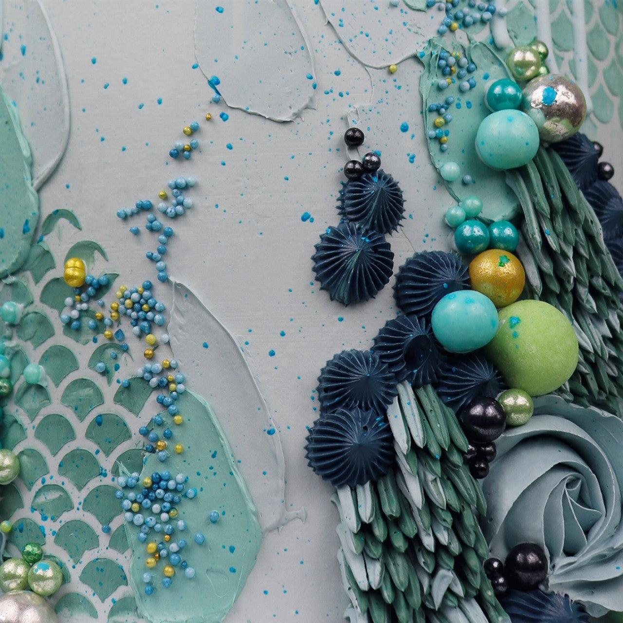 Mermaid-themed cake decorated with Sea Mist-colored buttercream and under-the-sea embellishments using Colour Mill pigment