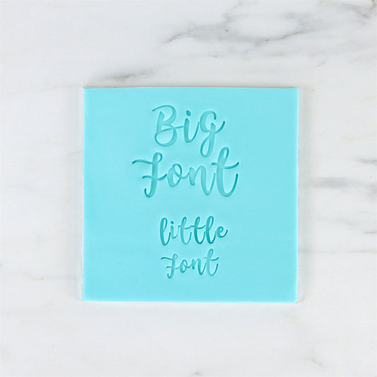 Embossed example of large and small fonts using PME Fun Fonts stamps on blue sugarpaste