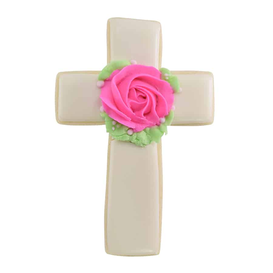 White cross-shaped cookie with a pink rose and green leaves in the center, ideal for religious gatherings or special occasions.