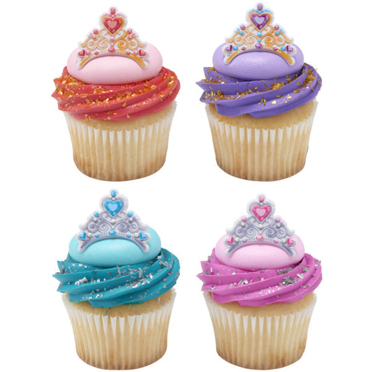 Cupcakes decorated with brightly colored frosting and topped with assorted tiara rings for a princess-themed party.