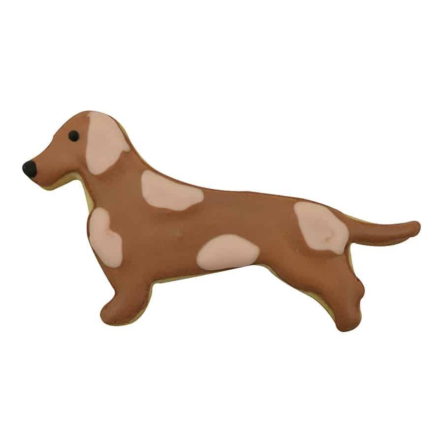 Decorated Dachshund-shaped cookie with brown and tan icing, featuring realistic dog markings.