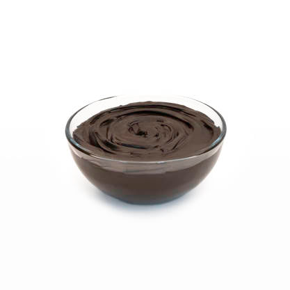 Glass bowl filled with dark chocolate ganache on a white background