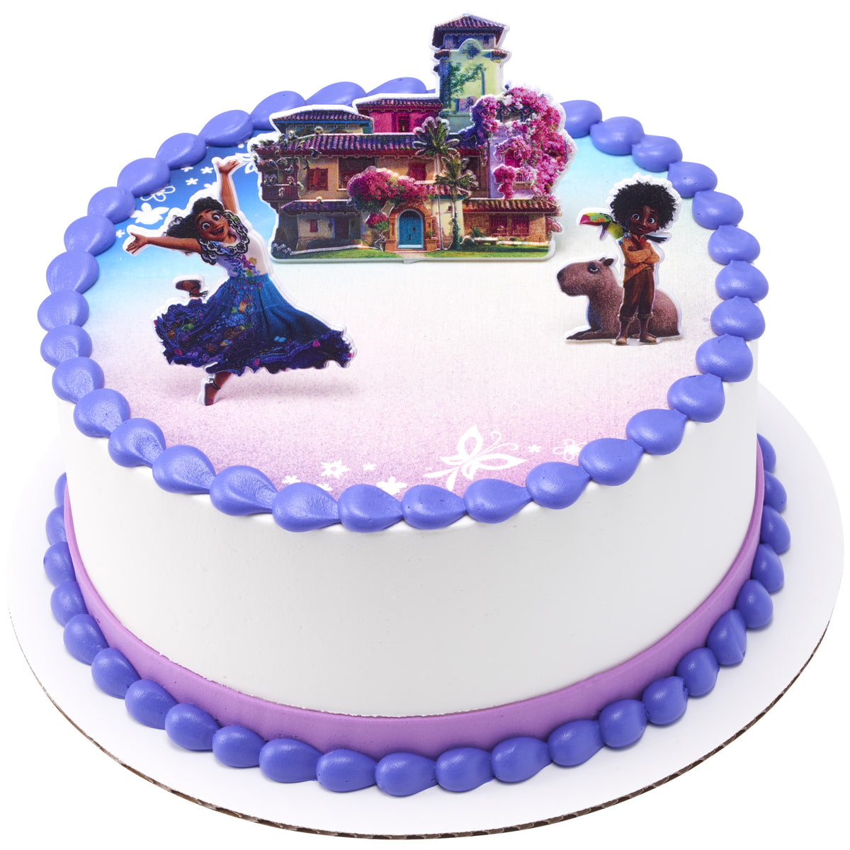 Round white Disney Encanto cake featuring Mirabel, Antonio, and the Madrigal family home cake picks with purple borders and a soft pink and blue floral design.