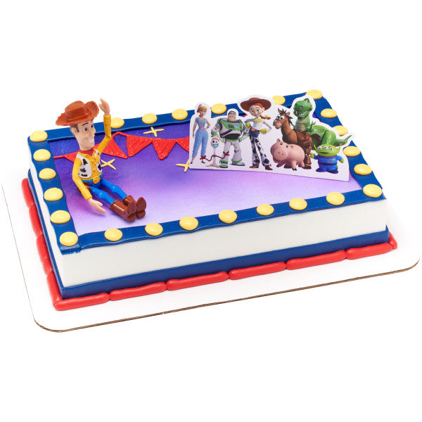 A rectangular cake decorated in a Toy Story theme with a marquee-style border, topped with the Woody & Friends DecoSet.