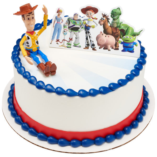 A round cake with a blue and red border, featuring the Woody & Friends DecoSet as the centerpiece.