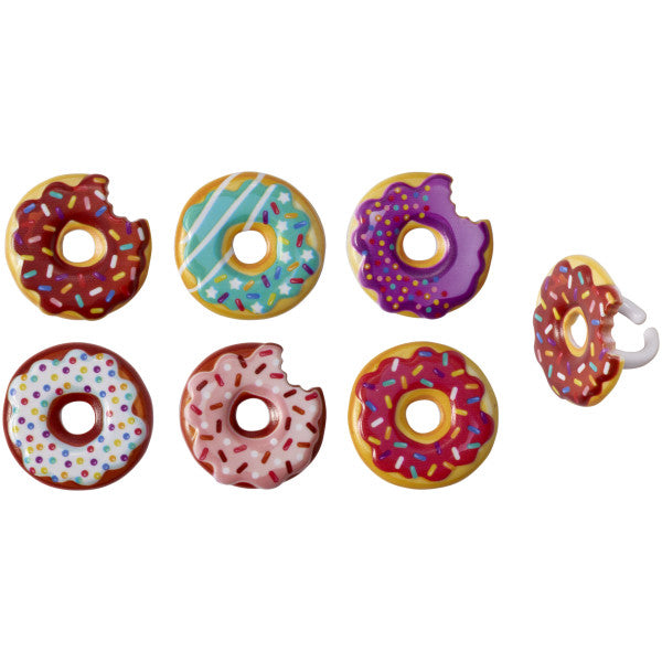 Assorted plastic donut rings with colorful frosting and sprinkles, in full and bitten styles, shown from various angles.