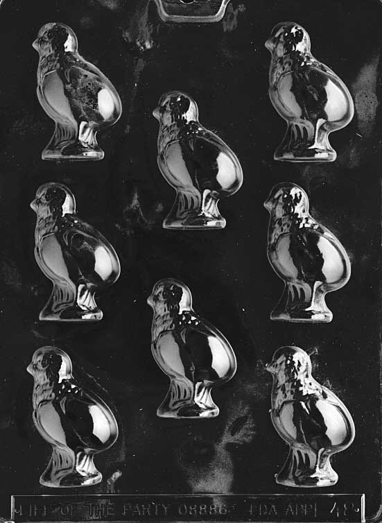 Mold of chick hatching from cracked egg with raised details and round shape.