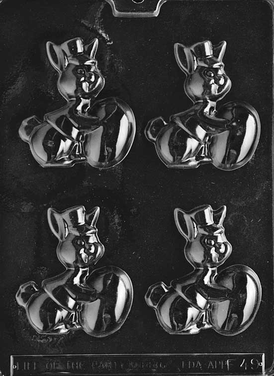 Chocolate mold with bunny sitting beside a decorated Easter egg.