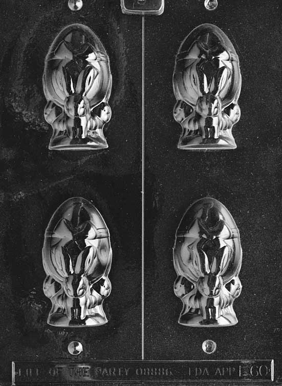 Hollow chocolate mold of bunny next to egg, with raised springtime details.