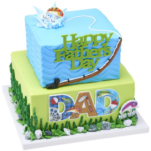 Two-tiered Father’s Day cake with fishing-themed decorations including lure cupcake rings and a “Happy Father’s Day” topper.