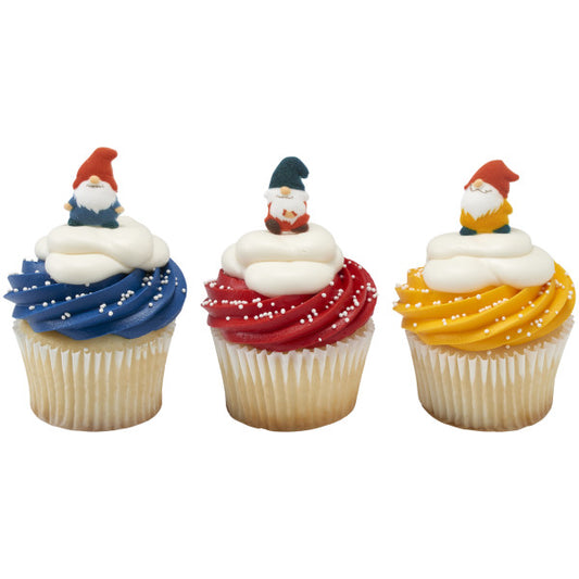 Three vanilla cupcakes with blue, red, and yellow frosting swirls topped with white frosting dollops and white sugar pearls, each finished with a pressed sugar gnome decoration.