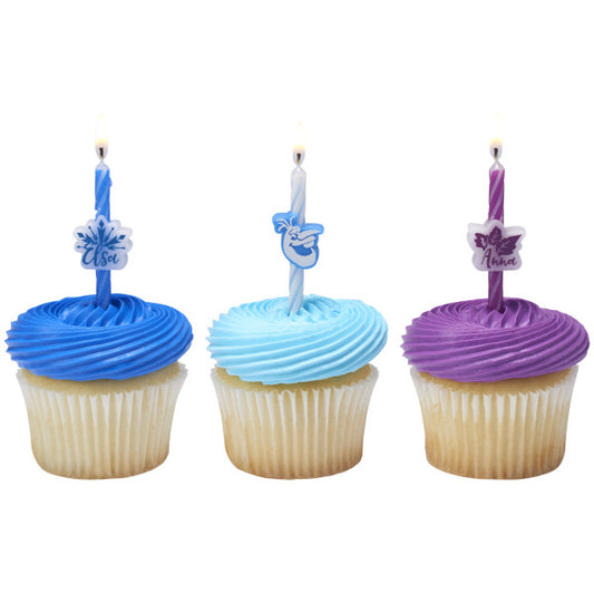 Three vanilla cupcakes topped with blue, light blue, and purple frosting and Frozen II candles featuring Elsa, Olaf, and Anna.
