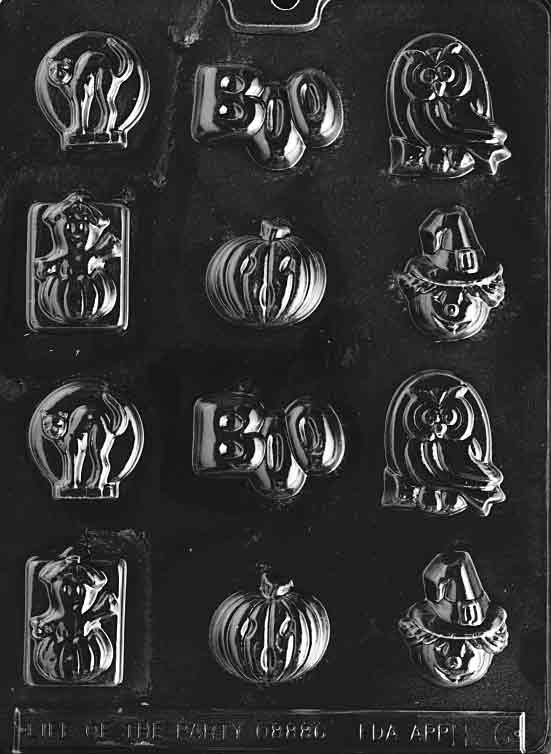 Clear multi-cavity Halloween chocolate mold featuring small designs: black cat, “BOO” letters, owl, scarecrow, and pumpkin, arranged in rows on a glossy plastic sheet.
